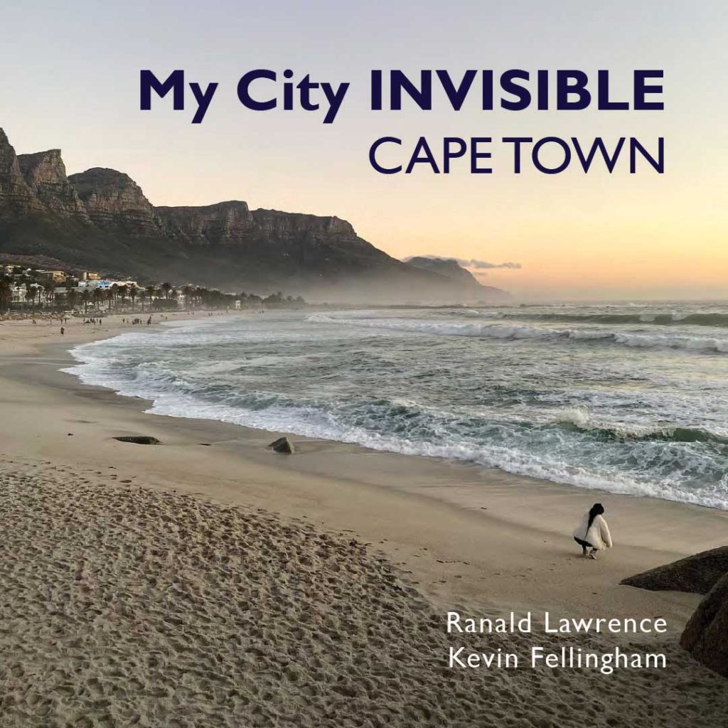 Woman crouching on sandy beach in front of palm trees and mountains at sunset. Text reads "My city INVISIBLE
CAPE TOWN, Ranald Lawrence, Kevin Felligham".